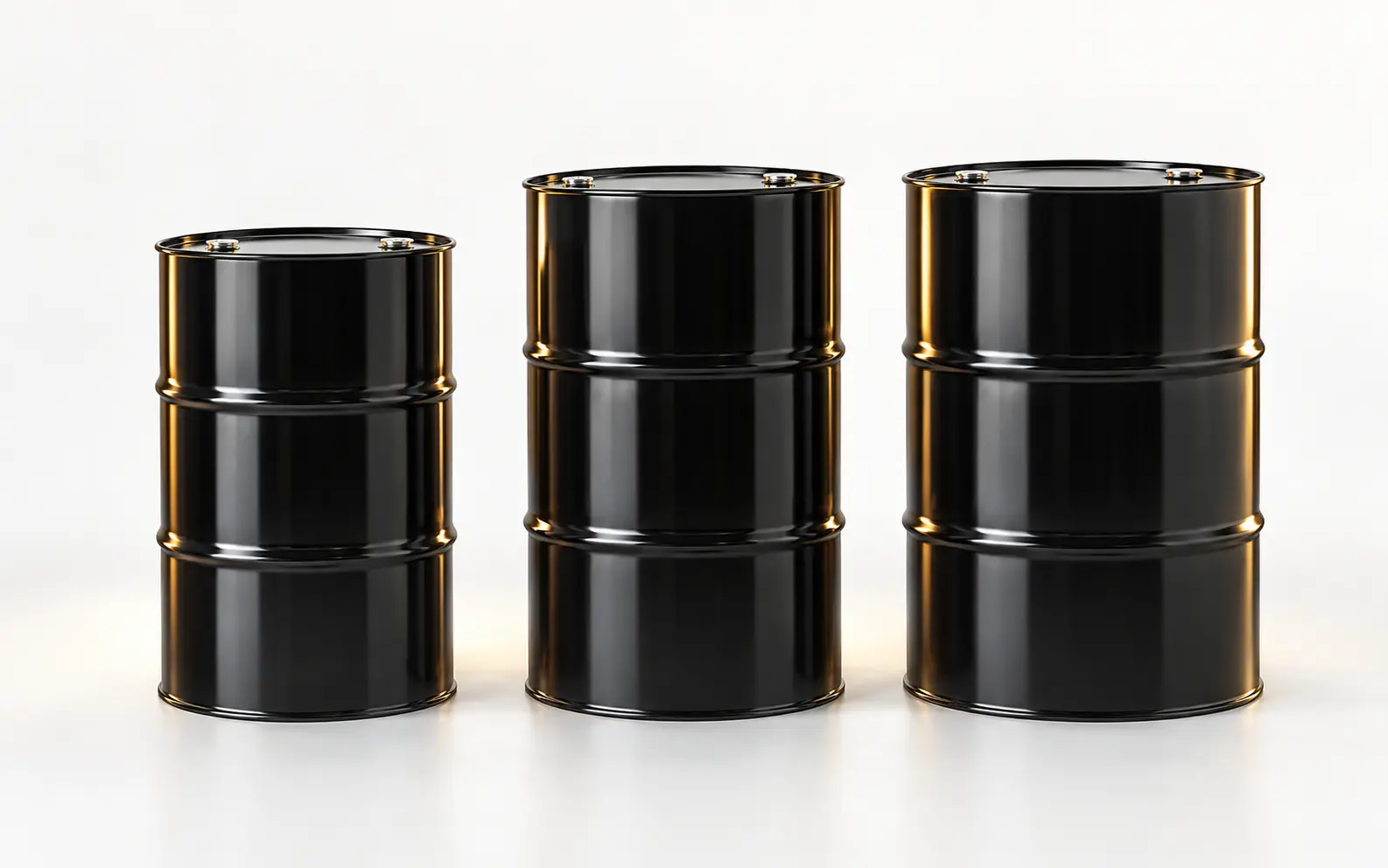 Three black steel bitumen drums